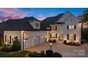 Elegant white home featuring a three-car garage, manicured landscaping, and inviting entrance at 356 Yacht Rd, Mooresville, NC 28117