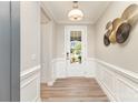 Inviting home foyer with light walls, elegant wall trim, modern lighting, and views of the outdoors at 3618 Marchers Trace Dr, Mint Hill, NC 28227
