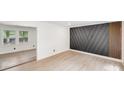 A versatile room featuring an accent wall with modern wood design details and light wood floors at 3619 Bankston Pl, Charlotte, NC 28215