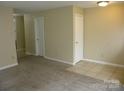 Spacious living room with neutral walls, plush carpeting, and tile entryway near interior doors at 391 Morning Dew Dr, Concord, NC 28025