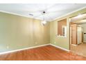 Empty dining room featuring wood floors, neutral walls, crown molding and hanging light fixture at 5310 Waverly Lynn Ln, Charlotte, NC 28269