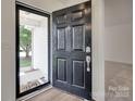 Close up of front door with storm door, dark wood door, and visible exterior view at 605 Summey Farm Dr, Dallas, NC 28034