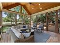 Inviting screened-in porch with vaulted wood ceiling, comfortable seating, and scenic outdoor views at 6202 Providence Country Club Dr, Charlotte, NC 28277
