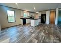 Modern kitchen with white cabinets, black appliances, and a center island at 796 Old Wilkesboro Rd, Taylorsville, NC 28681