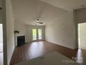 Bright and airy living room featuring a fireplace, hardwood floors, and French doors that lead to the patio at 9027 Mcdowell Creek Ln, Cornelius, NC 28031