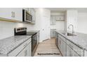 Modern kitchen featuring granite countertops, stainless steel appliances, and light gray cabinets at 906 Two Brothers Ln, York, SC 29745
