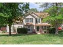 Charming two-story home with a well-maintained lawn and mature trees providing shade at 101 Canopy Ct, Mooresville, NC 28115
