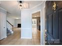 Inviting foyer showcasing tiled floors leading to the living room and kitchen area at 10943 Winterbourne Ct, Charlotte, NC 28277