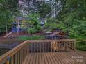 A multi-level home with a lush, wooded backyard with lake views, a boat house and a lakeside deck at 1114 Palmyra Dr, Tega Cay, SC 29708