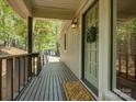 A cozy front porch features a green front door with a wreath, a welcome mat, and a wood-paneled ceiling at 1114 Palmyra Dr, Tega Cay, SC 29708