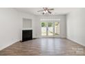 Bright living room featuring wood floors, a fireplace, and french doors leading to the outside at 11229 Lions Mane St, Charlotte, NC 28273