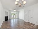 Spacious living room with hardwood floors, a fireplace, and a chandelier at 11229 Lions Mane St, Charlotte, NC 28273