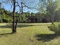 Cozy brick home surrounded by a generous lawn and mature trees, offering curb appeal at 12016 Brief Rd, Charlotte, NC 28227