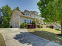 A paved driveway leads to a well-maintained home with a three-car garage at 1222 Kings Bottom Dr, Fort Mill, SC 29715