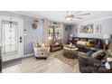 Inviting living room with ample natural light, a ceiling fan, decorative accents, and comfortable leather seating at 1279 Rocky Creek Rd, Shelby, NC 28152