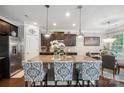 Well-designed kitchen featuring a granite island, stainless steel appliances, and dark cabinetry at 13402 David Jennings Ave, Charlotte, NC 28213