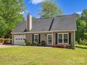 Charming single-story home featuring lush green lawn and mature landscaping at 1758 Bridlewood Ct, Gastonia, NC 28054