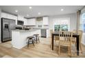 Bright kitchen with island seating flows into a dining area with backyard views at 2067 Stephens Farm Dr, China Grove, NC 28023