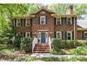 Charming brick home featuring a bright blue front door and manicured landscaping at 208 Devonport Dr # 25, Weddington, NC 28104