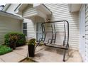 Cozy front porch with a charming swing, enhanced by potted flowers and a welcoming entrance at 21136 Cold Spring Ln, Cornelius, NC 28031