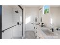 Bright bathroom featuring a walk-in shower, double vanity, and modern fixtures at 233 Cherokee Rose Ln # 31, Charlotte, NC 28217