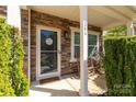 Inviting front porch with stone accents, a 'Welcome' sign and cozy seating, perfect for relaxing at 246 Mallard Head Dr, Rock Hill, SC 29732