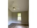 Bedroom with hardwood floors, neutral walls, a window view, and modern ceiling fan at 2473 Greenwood Rd, Rock Hill, SC 29730