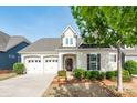 Inviting home with a two-car garage, neat landscaping, and a welcoming entrance at 3001 Henshaw Rd, Waxhaw, NC 28173