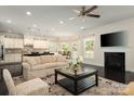 Bright living room open to the kitchen featuring a fireplace and neutral decor at 3001 Henshaw Rd, Waxhaw, NC 28173