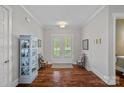 Elegant foyer featuring hardwood floors, a decorative cabinet, and French doors at 309 Catawba Ave, Davidson, NC 28036