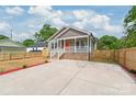 Beautiful home featuring a concrete driveway, a fenced yard, and professional landscaping at 320 Evans Nw St, Concord, NC 28027