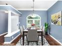 Dining room showcasing a modern chandelier, large window, and neutral paint; ideal for entertaining at 3200 Tallia Ct, Charlotte, NC 28269