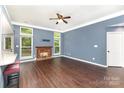 Bright living room featuring a fireplace, ceiling fan, and neutral decor; ready for furnishings at 3200 Tallia Ct, Charlotte, NC 28269
