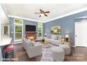 Bright living room featuring a fireplace, ceiling fan, and neutral decor; perfect for relaxation at 3200 Tallia Ct, Charlotte, NC 28269