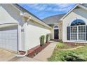 A detailed exterior featuring a well-kept lawn, fresh landscaping, and a two-car garage at 4606 Falcon Chase Sw Dr, Concord, NC 28027