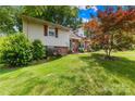 Charming split level home with lush landscaping and a well-manicured lawn at 4901 White Oak Rd, Charlotte, NC 28210