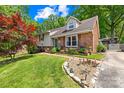 Well-maintained home featuring lush landscaping, a brick pathway and beautiful flowering plants at 4901 White Oak Rd, Charlotte, NC 28210