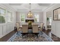 Elegant dining room featuring wainscoting, a coffered ceiling, and ample natural light for Gathering gatherings at 615 Welker St, Charlotte, NC 28204
