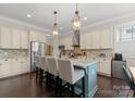 Spacious kitchen with a center island, stainless steel appliances, and stylish pendant lighting at 615 Welker St, Charlotte, NC 28204