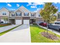 Attractive townhome exteriors with attached garages and well-maintained landscaping at 7004 Everly Commons Ln, Tega Cay, SC 29708