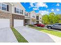 Beautiful townhomes boast attached garages, long driveways, and tidy landscaping at 7004 Everly Commons Ln, Tega Cay, SC 29708