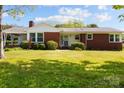 Charming single-story brick home with manicured lawn and well-maintained landscaping at 7209 Marley Cir, Charlotte, NC 28214