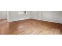 Bedroom with wood floors, large window, and closet at 7309 Pebblestone Dr # D, Charlotte, NC 28212