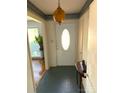 Inviting foyer with vintage light fixture, decorated wallpaper, and tiled floor at 7431 Idlewild Rd, Charlotte, NC 28212