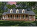 Charming red brick home featuring a welcoming front porch and well-maintained lawn at 781 Summerwood Dr, Rock Hill, SC 29732