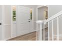 Bright entryway featuring wood floors, staircase and a white front door at 781 Summerwood Dr, Rock Hill, SC 29732