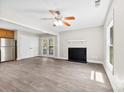 Bright living room with hardwood floors, fireplace, and French doors leading to the outdoors at 7905 Quail Field Dr, Charlotte, NC 28227