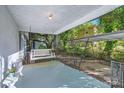 Relaxing front porch showcases a swing and covered carport beyond at 828 Richard Ave, Kannapolis, NC 28081