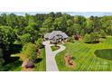 Stunning aerial view of the home with lush landscaping and a circular driveway at 8670 Arbor Oaks Cir, Concord, NC 28027