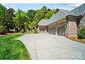 Spacious driveway and three car garage, offering ample parking at 8670 Arbor Oaks Cir, Concord, NC 28027